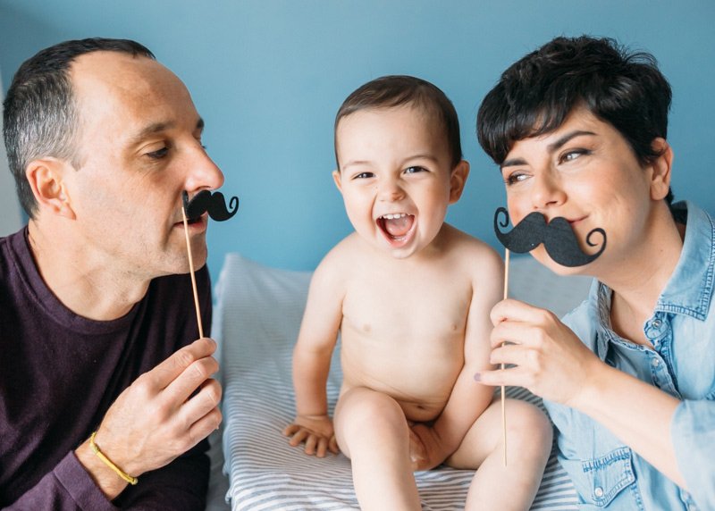 Fotos en familia en Bilbao con padres y niño sobre la cama pasandolo bien en Bilbao Bizkaia; fotografo reportaje de familia bilbao